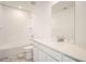 Clean bathroom features tile floors, modern fixtures, large mirror, and a bathtub with shower at 11052 Snowdon St, Parker, CO 80134