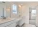 Elegant bathroom with dual sinks, quartz countertops, vanity space, and a glass-enclosed shower at 11052 Snowdon St, Parker, CO 80134