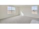 Bright bedroom with neutral carpet, large windows providing natural light, and ample space for furniture at 11052 Snowdon St, Parker, CO 80134