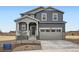 Charming two-story home with a welcoming porch, attached two-car garage, and professionally landscaped front yard at 11052 Snowdon St, Parker, CO 80134