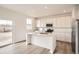 Modern kitchen boasts stainless steel appliances, white cabinetry, an island, and a stylish breakfast bar at 11052 Snowdon St, Parker, CO 80134