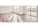 Open floor plan featuring hardwood floors, a large window, and a sliding glass door that allows ample sunlight at 11052 Snowdon St, Parker, CO 80134