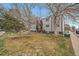A view of the two-story building exterior surrounded by grassy areas and trees at 16259 W 10Th Ave # A4, Golden, CO 80401
