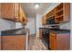 Functional kitchen showcasing wood cabinets, sleek appliances, and efficient use of space at 16259 W 10Th Ave # A4, Golden, CO 80401