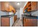 Efficient kitchen with wood cabinets, modern appliances, and open layout for cooking and entertaining at 16259 W 10Th Ave # A4, Golden, CO 80401