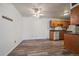Compact kitchen featuring wood-style floors, cabinets, and a ceiling fan, adjacent to living space at 16259 W 10Th Ave # A4, Golden, CO 80401