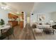 Living room view with wood-style floors transitioning into an open kitchen with dining area at 16259 W 10Th Ave # A4, Golden, CO 80401