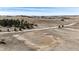 Aerial view of the property featuring a horse training ring, a country road and scattered trees at 1991 County Road 132, Elizabeth, CO 80107