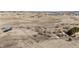 Scenic aerial view of property with rolling terrain, scattered trees, a pond and distant houses at 1991 County Road 132, Elizabeth, CO 80107