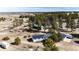 Aerial view of the residence with solar panels and outbuildings, surrounded by trees and vast open land at 1991 County Road 132, Elizabeth, CO 80107