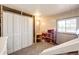 Cozy bedroom with carpet, a play area, and large closet with ample storage space at 1991 County Road 132, Elizabeth, CO 80107