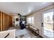 Mudroom-style entry features built-in seating, laundry, and convenient access to the outdoor deck at 1991 County Road 132, Elizabeth, CO 80107