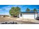 Detached garage with solar panels and concrete driveway at 1991 County Road 132, Elizabeth, CO 80107