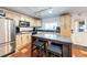 Functional kitchen with stainless steel appliances, custom cabinets, and a convenient kitchen island at 1991 County Road 132, Elizabeth, CO 80107