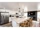 Modern kitchen with stainless steel appliances, marble countertops, a kitchen island, and open to the living room at 1991 County Road 132, Elizabeth, CO 80107