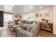 Bright and inviting living room with a large sectional sofa, a bay window, and tasteful decor for a relaxing atmosphere at 1991 County Road 132, Elizabeth, CO 80107