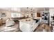 View of the open-concept living room and kitchen featuring a large kitchen island and comfortable furniture at 1991 County Road 132, Elizabeth, CO 80107