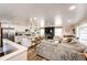 Open-concept living space featuring a kitchen island, modern appliances, a cozy sofa, and a fireplace with a large tv at 1991 County Road 132, Elizabeth, CO 80107