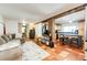 Inviting living area leading to the kitchen, with tile floors, a comfortable sofa, and natural light at 1991 County Road 132, Elizabeth, CO 80107