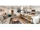 Open-concept living room and kitchen boasts hardwood floors, granite countertops, and island with bar stool seating at 1991 County Road 132, Elizabeth, CO 80107
