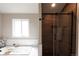 Modern bathroom with wood accent wall, glass shower doors, and a luxurious soaking tub at 1772 Eisenhower, Louisville, CO 80027