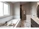 A stunning bathroom featuring white marble floors, a soaking tub, and dual vanities at 1772 Eisenhower, Louisville, CO 80027