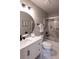 Beautiful bathroom with modern fixtures, white vanity, marble shower and round mirror at 1772 Eisenhower, Louisville, CO 80027
