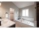Luxurious bathroom features a soaking tub, marble countertops and double sinks at 1772 Eisenhower, Louisville, CO 80027