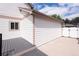 Exterior view with a deck, white siding, and a convenient concrete driveway at 1772 Eisenhower, Louisville, CO 80027