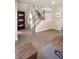 Inviting home foyer with hardwood floors and natural light leading to the staircase at 1772 Eisenhower, Louisville, CO 80027