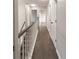 Hallway view featuring dark wood flooring, neutral walls, and bright, natural lighting at 1772 Eisenhower, Louisville, CO 80027