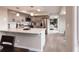 Modern kitchen with stainless steel appliances, white quartz countertops, and views to the Gathering room at 1772 Eisenhower, Louisville, CO 80027