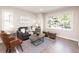 Cozy living room with large window, hardwood floors, comfortable seating, and modern decor at 1772 Eisenhower, Louisville, CO 80027