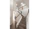 Beautiful staircase with wooden steps, white railings, and great lighting at 1772 Eisenhower, Louisville, CO 80027