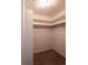 Walk-in closet with wood floor and ample shelving for storage at 1772 Eisenhower, Louisville, CO 80027