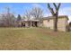 Grassy backyard with covered patio, perfect for outdoor relaxation at 12020 W Center Ave, Lakewood, CO 80228