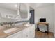 Well-lit bathroom featuring double sinks, stylish tile accents, and modern fixtures at 12020 W Center Ave, Lakewood, CO 80228