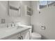 Bathroom with sleek white vanity, modern faucet, and toilet at 12020 W Center Ave, Lakewood, CO 80228