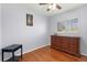 Bright bedroom with a classic dresser, hardwood floors, and a serene atmosphere at 12020 W Center Ave, Lakewood, CO 80228