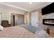 Modern bedroom featuring a stone accent wall, fireplace, and access to closet at 12020 W Center Ave, Lakewood, CO 80228