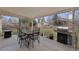 Outdoor covered patio featuring dining set, grill, and backyard view, perfect for entertaining and relaxation at 12020 W Center Ave, Lakewood, CO 80228