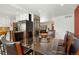 Open floor plan dining room next to the kitchen and features a glass top table at 12020 W Center Ave, Lakewood, CO 80228