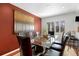 Cozy dining room features hardwood floors, bright white trim, and a glass-top table at 12020 W Center Ave, Lakewood, CO 80228