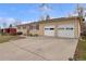 Single-story house with brick exterior, a two-car garage, and a spacious driveway at 12020 W Center Ave, Lakewood, CO 80228