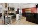 Modern kitchen with stainless steel appliances, white cabinets, and tiled backsplash at 12020 W Center Ave, Lakewood, CO 80228