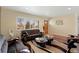 Bright and airy living room features hardwood floors, a comfortable sofa, and natural light at 12020 W Center Ave, Lakewood, CO 80228