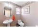 Half bath featuring a pedestal sink and toilet at 5039 Fontana Ct, Denver, CO 80239