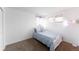 Bright bedroom with a twin bed, carpet and two windows at 5039 Fontana Ct, Denver, CO 80239