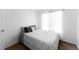 Bright bedroom featuring a queen-size bed, neutral decor, and natural light from the window at 5039 Fontana Ct, Denver, CO 80239