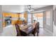 Open dining space with wood table, tile floors, and direct access to a well-appointed kitchen at 5039 Fontana Ct, Denver, CO 80239